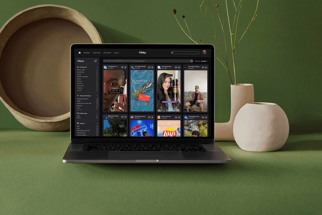 The Vidsy inspiration library on a laptop, on an olive-green desk